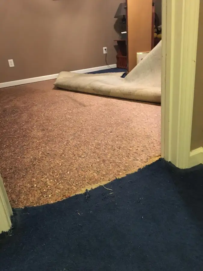 Carpet pad removal revealing water damage during Water Mitigation Services in Tinley Park